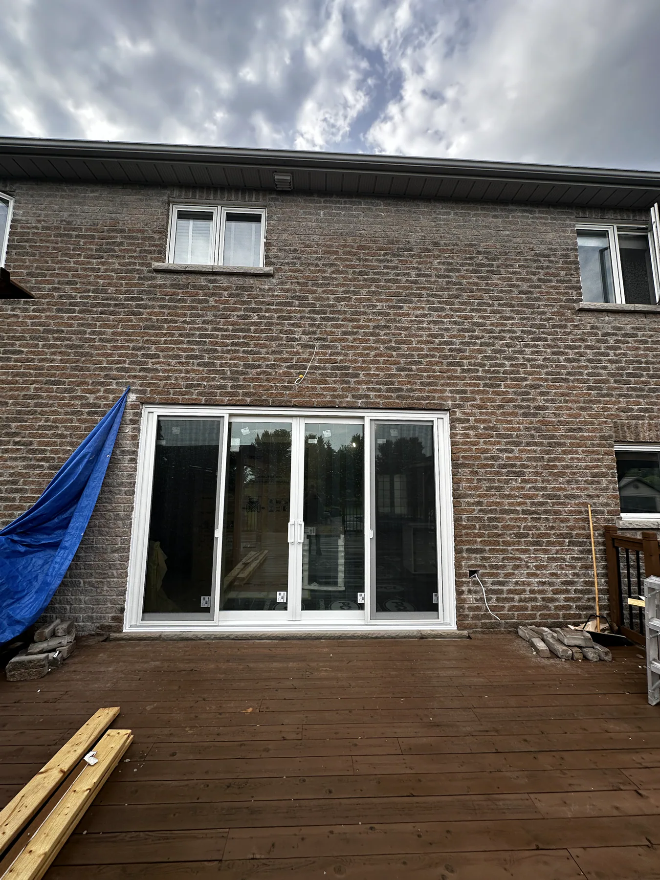 Finished multi-panel patio door installed in a wide brick opening